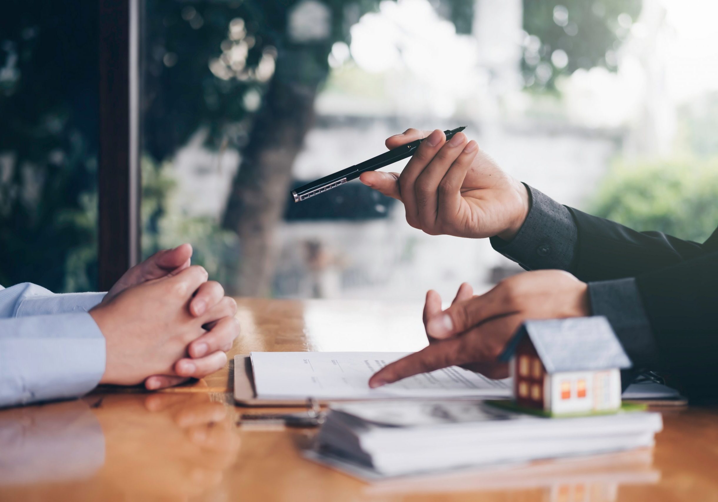 real estate agent holding house key to his client after signing contract,concept for real estate, moving home or renting property